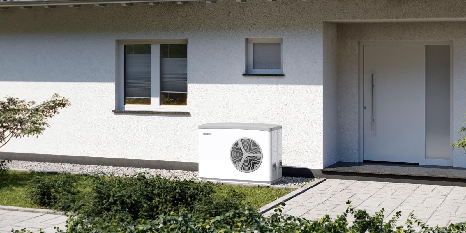Eine Waermepumpe vor einem Wohngebaeude